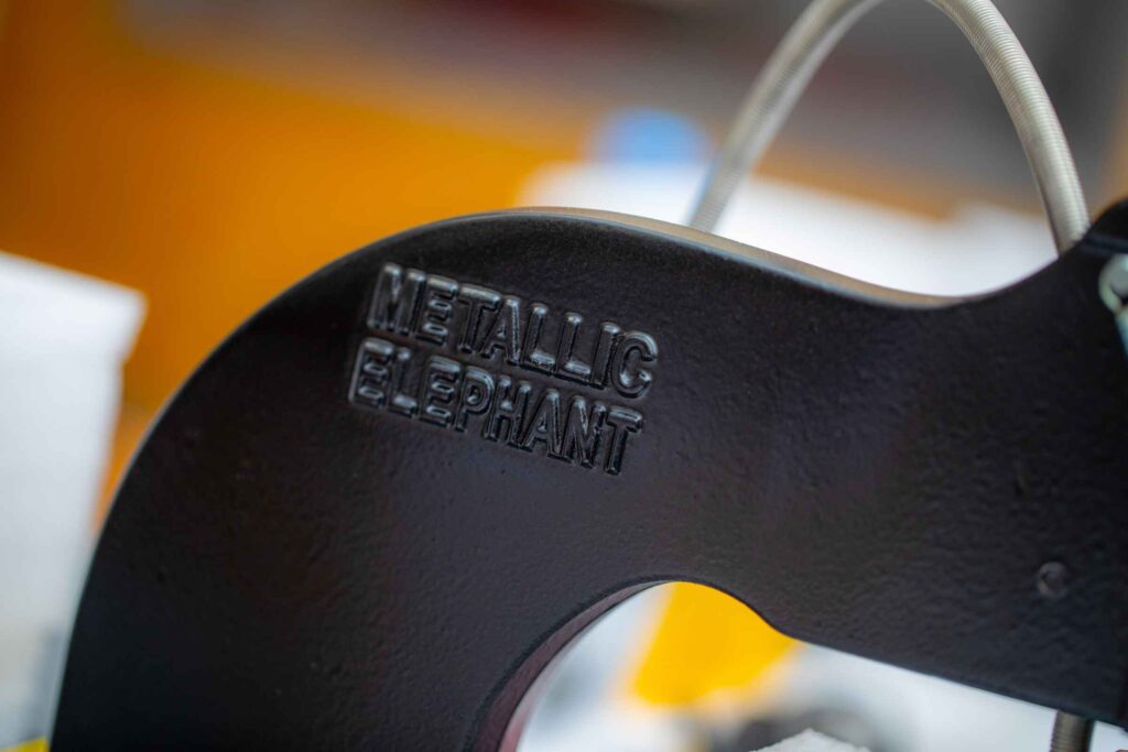 Close up of a Metallic Elephant logo on a hot foil press machine